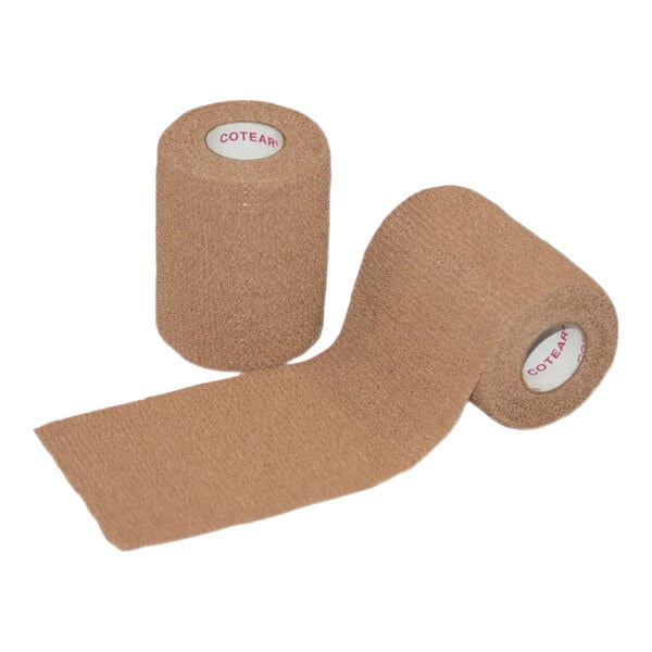 A pair of tan self-adhering medical wraps, one rolled and one partially unrolled.