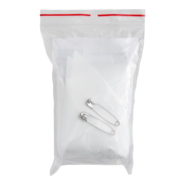 A clear plastic bag containing a non-woven cotton triangular bandage and two safety pins.