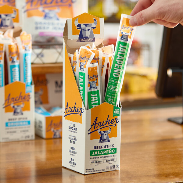 A box of Archer Jalapeno Beef Sticks, each individually wrapped, displayed on a counter.