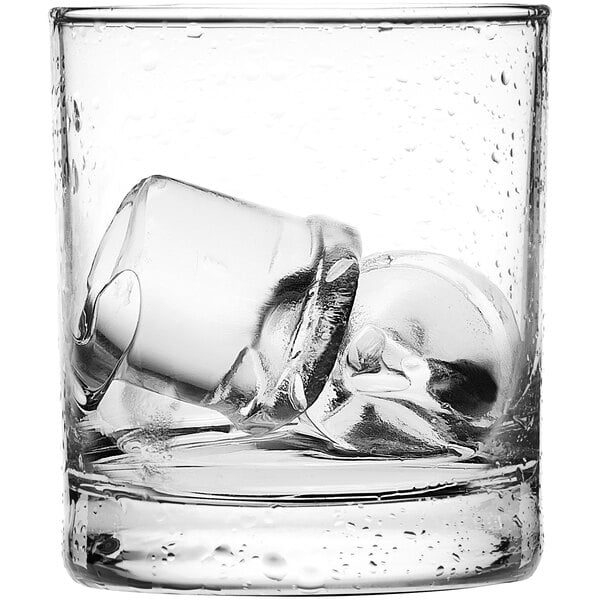 A clear glass containing two large, clear ice cubes.