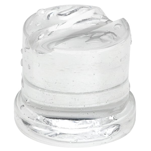 A clear, cylindrical gourmet ice cube produced by an undercounter ice machine.