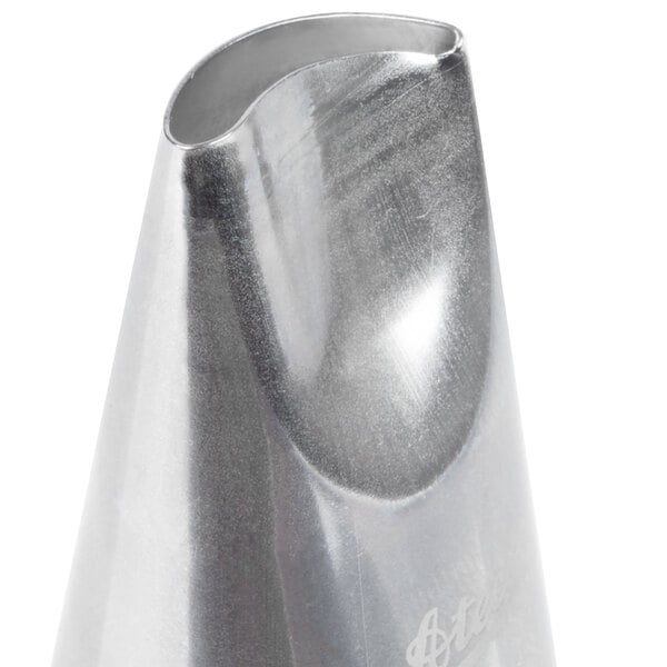 A metal curved petal piping tip used for cake decorating.