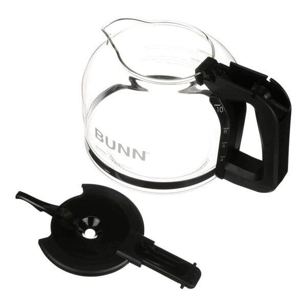 A glass coffee decanter with a black handle and a separate black plastic lid assembly.