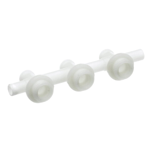 A white plastic triple manifold for plumbing or fluid distribution applications.