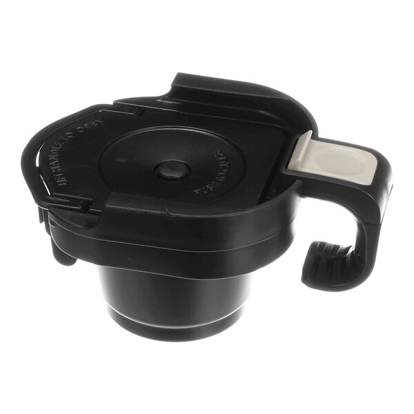 An adapter assembly cartridge for a Bunn MCU coffee maker, made of black plastic with a white button.