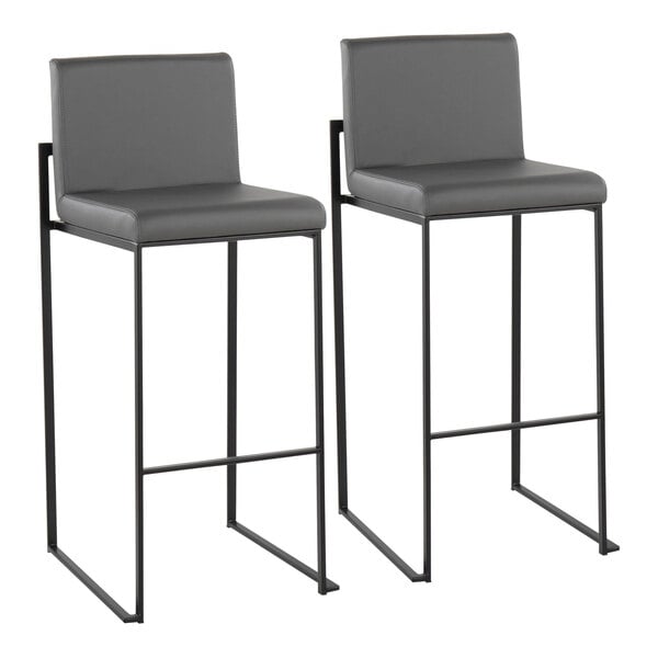 A pair of modern barstools with black steel frames and gray faux leather seats and backs.
