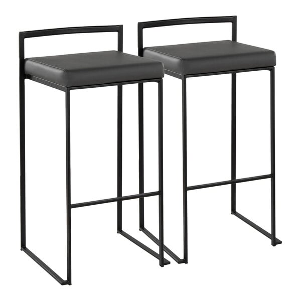 A pair of black metal stackable low-back barstools with gray faux leather seats.