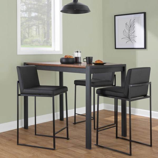 A set of two high-back barstools with black steel frames and black faux leather seats and backs.