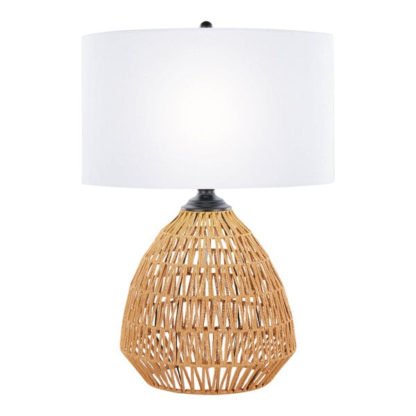A table lamp with a natural rattan woven base and a white linen drum shade.