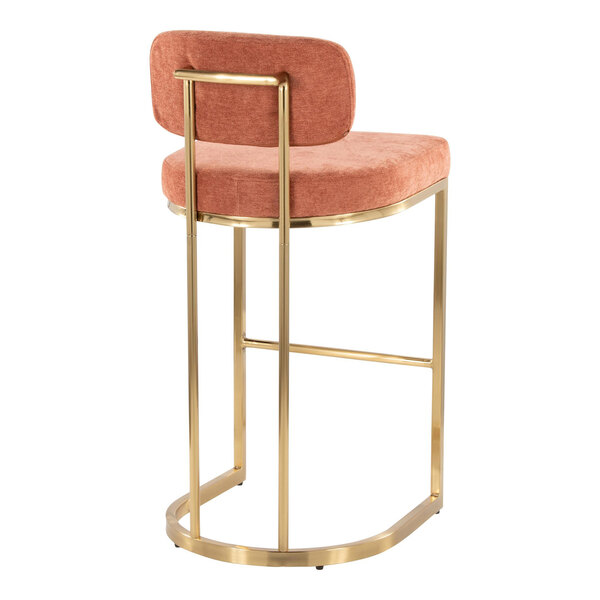 A modern barstool with a gold metal frame and salmon-colored fabric seat and backrest.