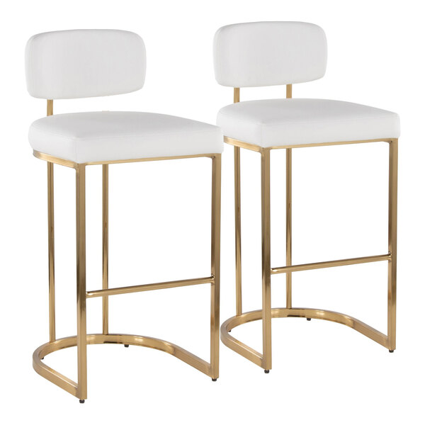A pair of barstools with gold metal frames and white faux leather seats and backs.