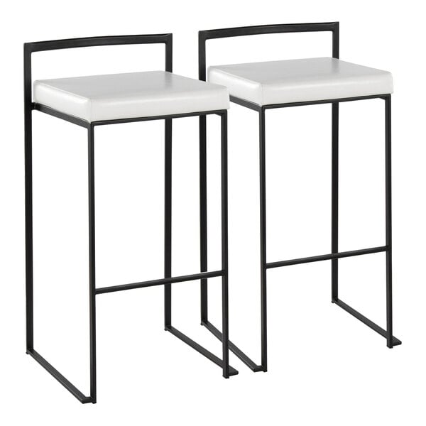 A pair of black metal barstools with low backs and white faux leather seats.