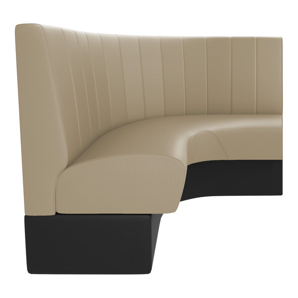 A large, curved beige booth with vertical channel stitching and a black base.