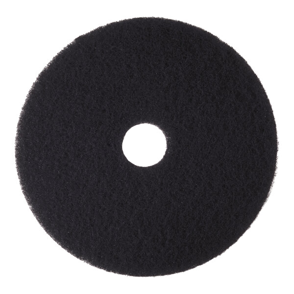 A round, black high-performance stripping floor pad with a hole in the center.