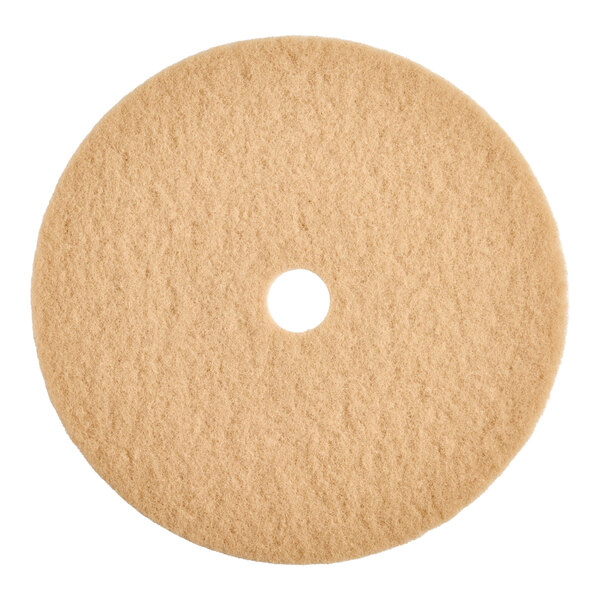 A round tan burnishing floor pad with a central hole, designed for use with low-frequency floor machines.