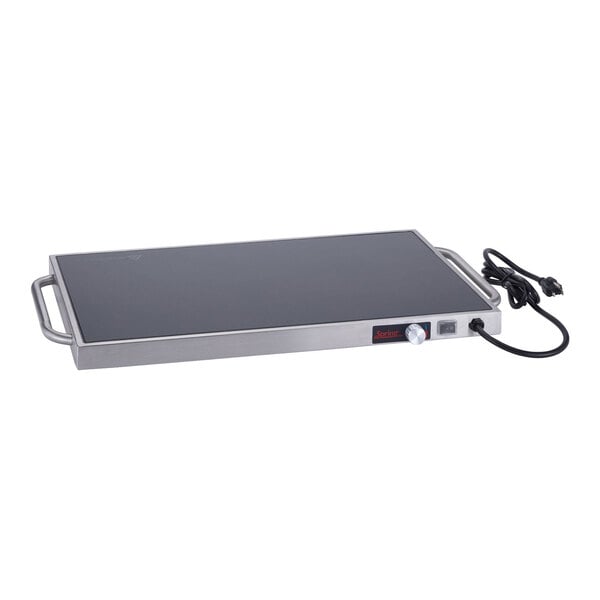 A rectangular stainless steel warming shelf with a black surface, side handles, and an attached power cord.