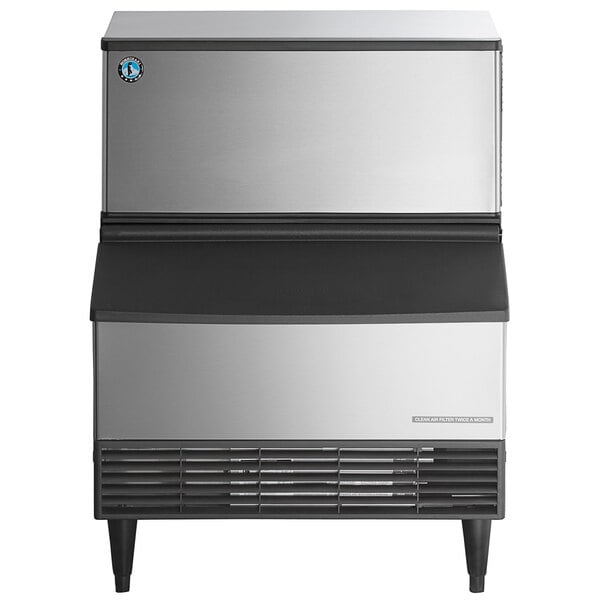 A stainless steel undercounter ice machine with a front air intake and black accents.