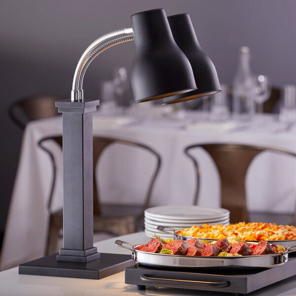 A stainless steel warming shelf with a double heat lamp, designed for keeping food warm.