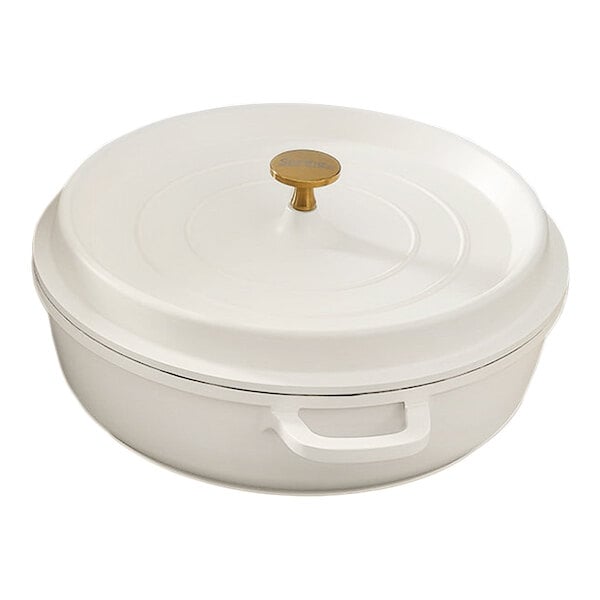 A white non-stick round casserole dish with a lid and a gold knob handle.