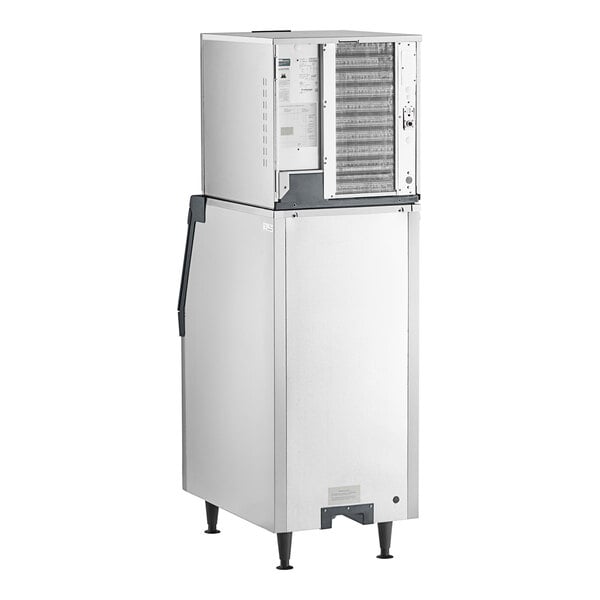 A commercial stainless steel ice machine with a storage bin.
