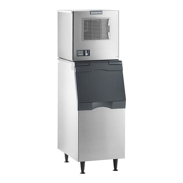 A commercial stainless steel ice machine with a black storage bin.