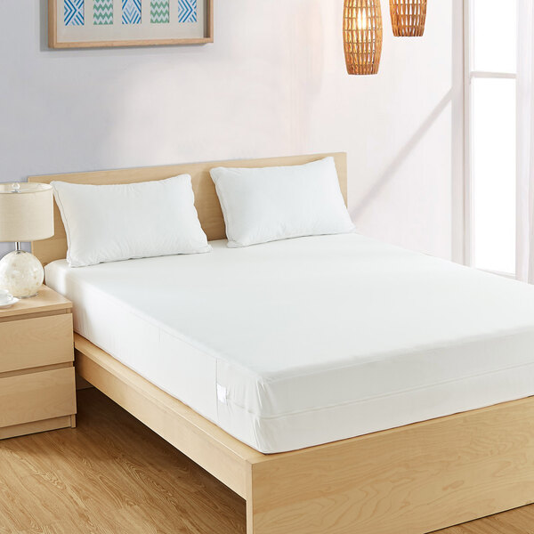 A king-size waterproof poly knit mattress protector on a bed.