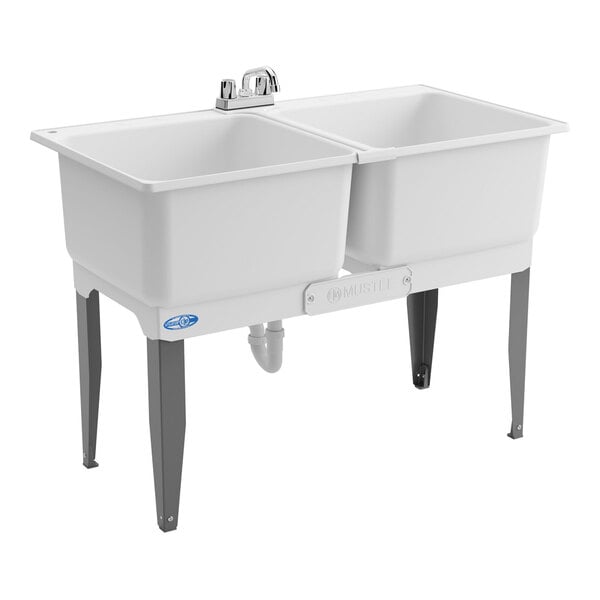 A double-compartment white utility laundry tub sink with steel legs and a faucet kit.