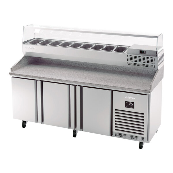 A stainless steel refrigerated pizza prep table with three doors, a granite work surface, and a top refrigerated ingredient rail.