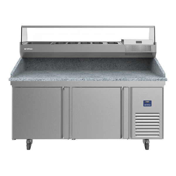 A stainless steel refrigerated pizza prep table with two doors and a granite work surface.