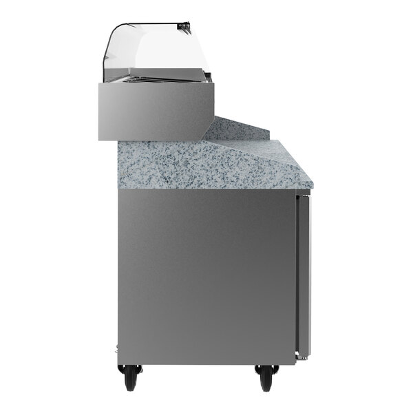 A stainless steel refrigerated pizza prep table with a granite worktop, two doors, and a raised ingredient rail.