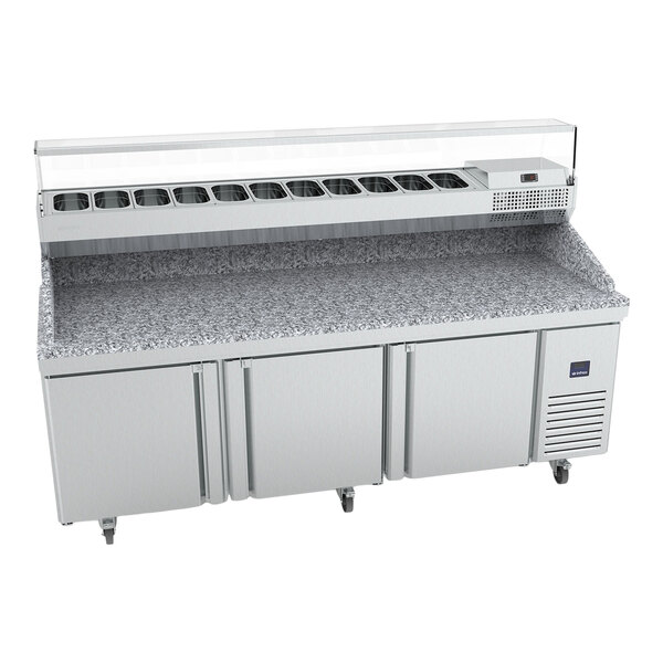 A large stainless steel refrigerated pizza prep table with three doors, a granite work surface, and a top refrigerated ingredient rail.