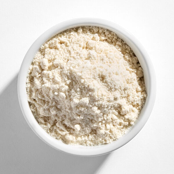 A white bowl filled with a light-colored, coarse powdery mix.