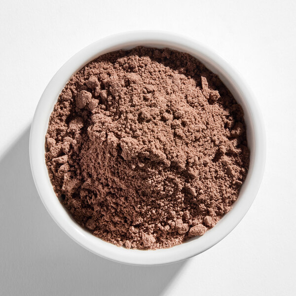 A white bowl filled with a light brown, finely textured powder.