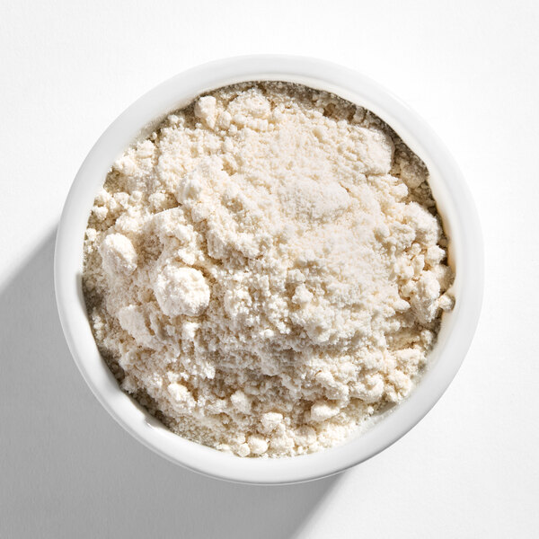 A white bowl filled with a light beige, powdery and slightly clumpy mixture.