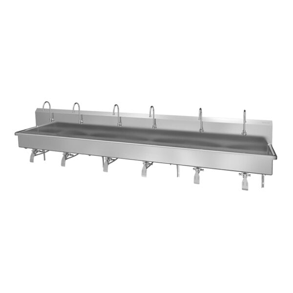 A large stainless steel wall-mounted sink with six faucets and knee pedal controls for hands-free operation.