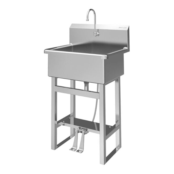 A stainless steel floor-mounted hands-free sink with a double foot-operated faucet.