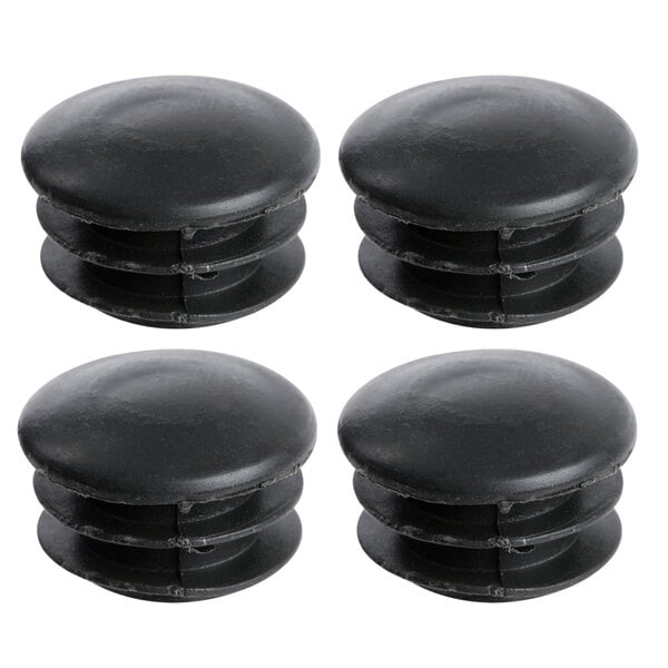 A close-up of 4 black plastic caps for shelving posts.