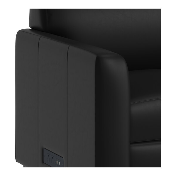 A black leather sofa with built-in charging banks on the armrest and wooden feet.