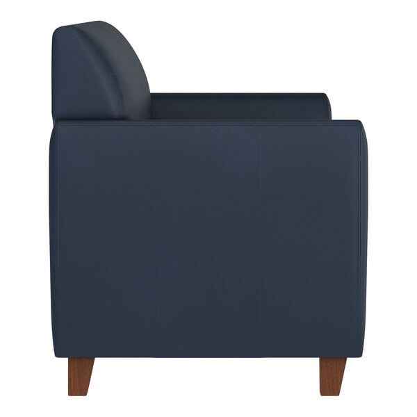 A navy blue loveseat with wooden feet and a boxy, modern design.