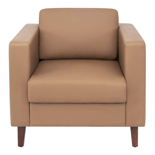 A cognac-colored leather armchair with wooden legs and a charging bank.