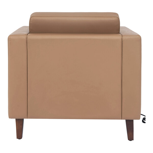 A cognac-colored leather chair with wooden feet and a built-in charging bank.