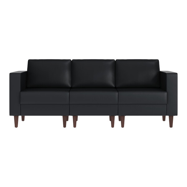 A black three-seat sofa with wooden legs and built-in charging banks.