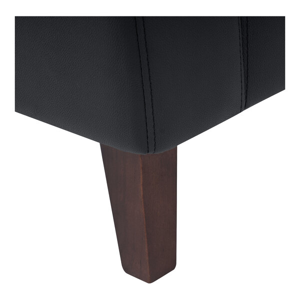 A close-up of a black upholstered chair with a wooden leg.