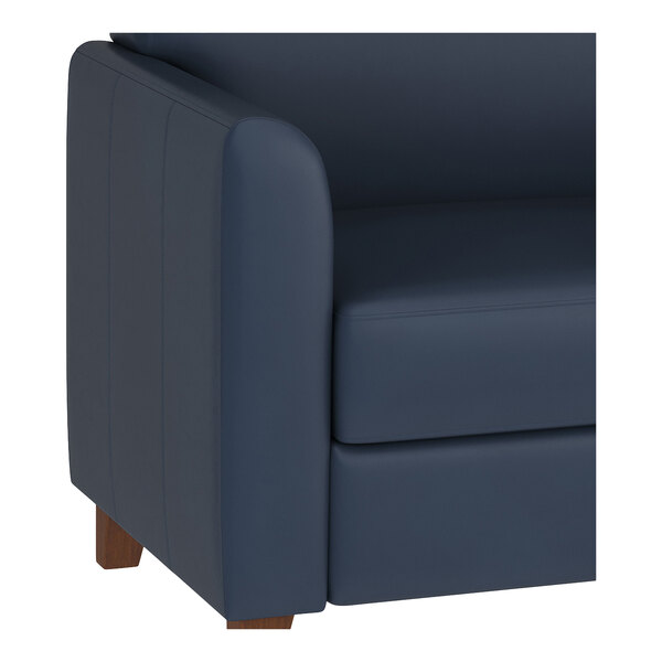 A navy blue leather chair with wooden feet and a modern design.