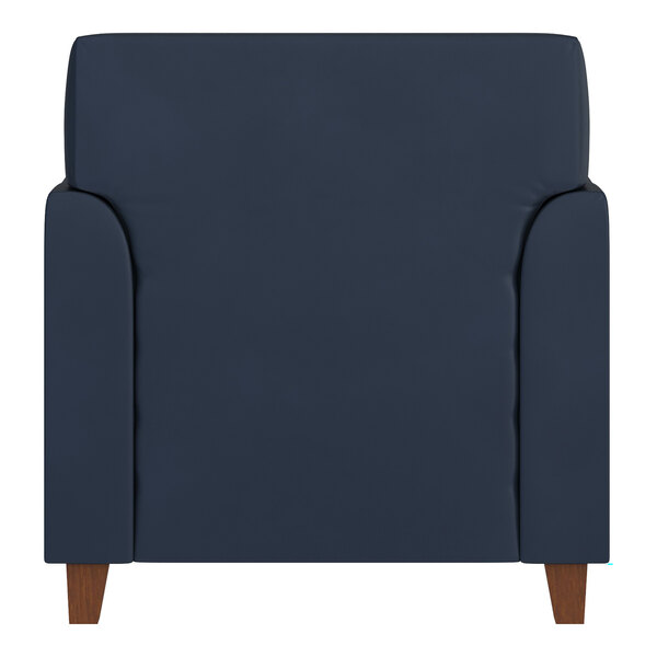 A navy blue upholstered armchair with wooden legs.
