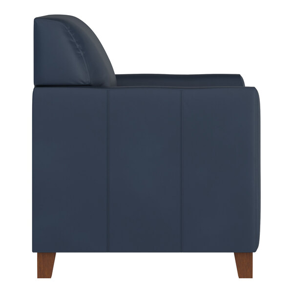 A navy blue leather chair with wooden feet and a boxy, modern design.