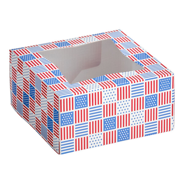 A square bakery box with a patriotic red, white, and blue USA-themed print and a clear window on top.