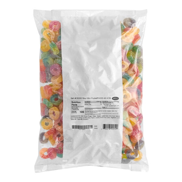 A clear plastic bag filled with assorted colorful sour mini gummy rings.