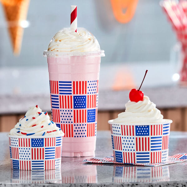 A 6 oz. paper frozen yogurt cup with a patriotic USA print design, shown filled with soft serve and toppings.