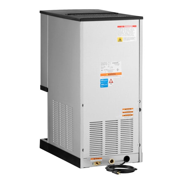 A silver Manitowoc air cooled countertop nugget ice maker and dispenser with a 10 lb. bin and solid panel sensor dispensing.